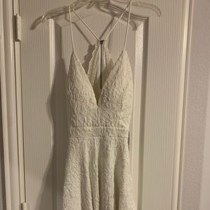 White Lacey mini dress with lace see through back size M.